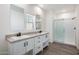 Modern bathroom with double vanity, sleek fixtures, and a walk-in shower at 51937 W Wildwood Rd, Maricopa, AZ 85139