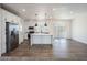 Modern kitchen with white cabinets, a large island, and stainless steel appliances at 51937 W Wildwood Rd, Maricopa, AZ 85139