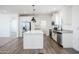 Bright, modern kitchen featuring white cabinetry, stainless steel appliances, and an island at 51937 W Wildwood Rd, Maricopa, AZ 85139