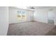Bright and airy living room with large windows and carpet at 51937 W Wildwood Rd, Maricopa, AZ 85139