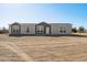 Charming two-story home with a gray and white exterior, front yard, and desert landscaping at 51983 W Wildwood Rd, Maricopa, AZ 85139