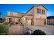 Two-story house with a three-car garage and landscaped front yard at dusk at 5907 W Running Deer Trl, Phoenix, AZ 85083