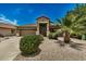 Single-story home with a two-car garage, desert landscaping, and palm trees at 692 E Dry Creek Rd, San Tan Valley, AZ 85143