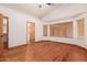 Main bedroom with hardwood floors, access to bathroom and closet at 7005 W Cavalier Dr, Glendale, AZ 85303