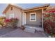 Front view of a single-story house with a covered porch and bougainvillea at 711 N Walnut Ave, Casa Grande, AZ 85122