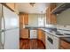 Kitchen with wood cabinets, granite countertops, and white appliances at 711 N Walnut Ave, Casa Grande, AZ 85122