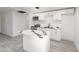 Stylish kitchen with white cabinetry, a marbled waterfall island, and stainless steel appliances at 7823 N 60Th Ave, Glendale, AZ 85301