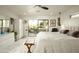 Main bedroom with king-size bed, private access to patio, and ceiling fan at 9919 N 47Th Pl, Phoenix, AZ 85028
