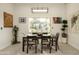 Modern dining room with large window and stylish light fixture at 9919 N 47Th Pl, Phoenix, AZ 85028