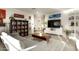 Living room with cozy seating, built-in shelving, and large TV at 9919 N 47Th Pl, Phoenix, AZ 85028