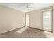 Well-lit bedroom featuring neutral walls and carpet at 10035 W Desert Rock Dr, Sun City, AZ 85351