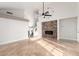 Living room with tile floors, fireplace, ceiling fan, and high ceilings at 12406 W Berry Ln, El Mirage, AZ 85335