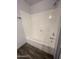 Clean bathroom with a bathtub/shower and wood-look tile at 12445 N 21St Ave # 31, Phoenix, AZ 85029