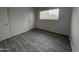 Bedroom featuring wood-look tile flooring and ample natural light at 12445 N 21St Ave # 31, Phoenix, AZ 85029