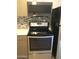 Kitchen with stainless steel appliances, including a microwave and stove at 12445 N 21St Ave # 31, Phoenix, AZ 85029