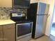 Kitchen featuring stainless steel appliances, including a refrigerator, stove, and microwave at 12445 N 21St Ave # 31, Phoenix, AZ 85029