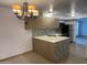 Kitchen with an island, modern light fixture, and stainless steel appliances at 12445 N 21St Ave # 31, Phoenix, AZ 85029