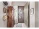 Welcoming foyer with a wooden cabinet, screen door, and wood-look tile flooring at 12484 W Alyssa Ln, Peoria, AZ 85383