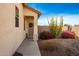 Front door with a screen door and desert landscaping at 12640 W Campina Dr, Litchfield Park, AZ 85340