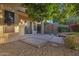 Private backyard patio with a decorative wall, lush trees, and desert landscaping at 13602 N 12Th Pl, Phoenix, AZ 85022