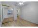 Simple bedroom featuring a mirrored sliding closet door and wood-look flooring at 13602 N 12Th Pl, Phoenix, AZ 85022