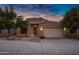 Charming two-story home with attached garage and landscaped front yard at sunset at 13602 N 12Th Pl, Phoenix, AZ 85022