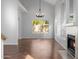 Dining room with wood floors, fireplace, and large window at 13635 N 103Rd Way, Scottsdale, AZ 85260