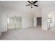 Large main bedroom with mirrored closet doors, carpeted flooring, and ceiling fan at 13635 N 103Rd Way, Scottsdale, AZ 85260