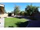 Backyard with grassy area, gravel, and mature trees at 14267 S 43Rd Pl, Phoenix, AZ 85044