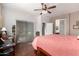 Bedroom with coral and white bedding, ceiling fan, desk, and wood laminate flooring at 15617 W Central St, Surprise, AZ 85374