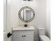 Stylish bathroom with white vanity, quartz countertop and round mirror at 15921 E Primrose Dr, Fountain Hills, AZ 85268