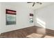 Bright bedroom with wood-look flooring, ceiling fan, and large windows at 18589 W Fulton St, Goodyear, AZ 85338