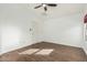 Spacious bedroom with wood-look floors, a ceiling fan, and simple decor at 18589 W Fulton St, Goodyear, AZ 85338