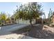 A single-story home with a two-car garage, desert landscaping, and a tree in the front yard at 18589 W Fulton St, Goodyear, AZ 85338