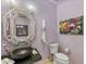 Powder room with unique vessel sink and decorative mirror at 2 E Biltmore Estates Dr # 115, Phoenix, AZ 85016