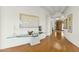 Elegant entry hall with hardwood floors, art, and glass-top table at 2 E Biltmore Estates Dr # 115, Phoenix, AZ 85016