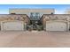 Two-car garage with stone exterior and paved driveway at 2 E Biltmore Estates Dr # 115, Phoenix, AZ 85016