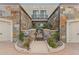 Front exterior view with double garages and walkway at 2 E Biltmore Estates Dr # 115, Phoenix, AZ 85016