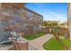 Relaxing patio with seating area, artificial turf, and stone pathway at 2 E Biltmore Estates Dr # 115, Phoenix, AZ 85016