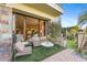 Outdoor patio with seating area, partial view into living area at 2 E Biltmore Estates Dr # 115, Phoenix, AZ 85016
