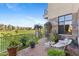 Stone patio with seating area and view of golf course at 2 E Biltmore Estates Dr # 115, Phoenix, AZ 85016