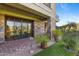 Brick patio with lush landscaping and sliding glass doors at 2 E Biltmore Estates Dr # 115, Phoenix, AZ 85016