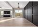 Dining area with sliding glass doors, a modern light fixture, and a black accent wall at 20939 S 225Th Way, Queen Creek, AZ 85142