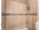 Bathroom with tiled shower and mosaic tile accents at 3303 E Longhorn Dr, Phoenix, AZ 85050