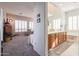 Main bedroom with attached ensuite bathroom and carpeted flooring at 3512 W Hidden Mountain Ct, Phoenix, AZ 85086