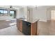 Kitchen island with granite countertop, double sink, dishwasher, and tile floors at 35306 N Zachary Rd, San Tan Valley, AZ 85144