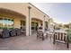 Covered patio with a fire pit, dining area, and comfortable seating at 36011 N Stoneware Dr, Queen Creek, AZ 85140