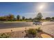 View of the street with landscaped walkways and community greenery at 36011 N Stoneware Dr, Queen Creek, AZ 85140