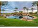 Tranquil water feature with palm trees and a waterfall at 36011 N Stoneware Dr, Queen Creek, AZ 85140