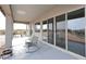 Covered back patio with seating, desert views, and sliding glass doors at 36023 N 140Th St, Scottsdale, AZ 85262